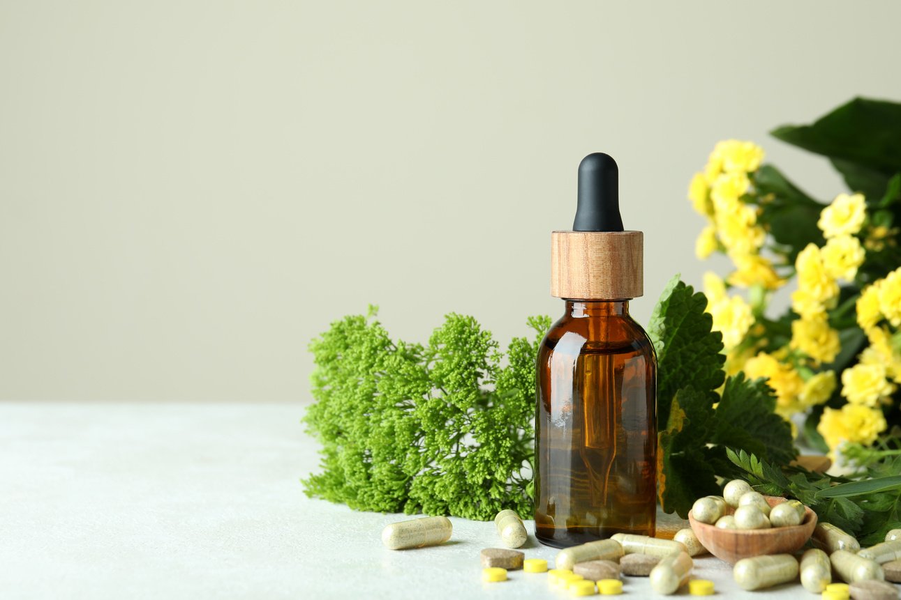 Concept of Herbal Medicine Pills on White Textured Table, Space